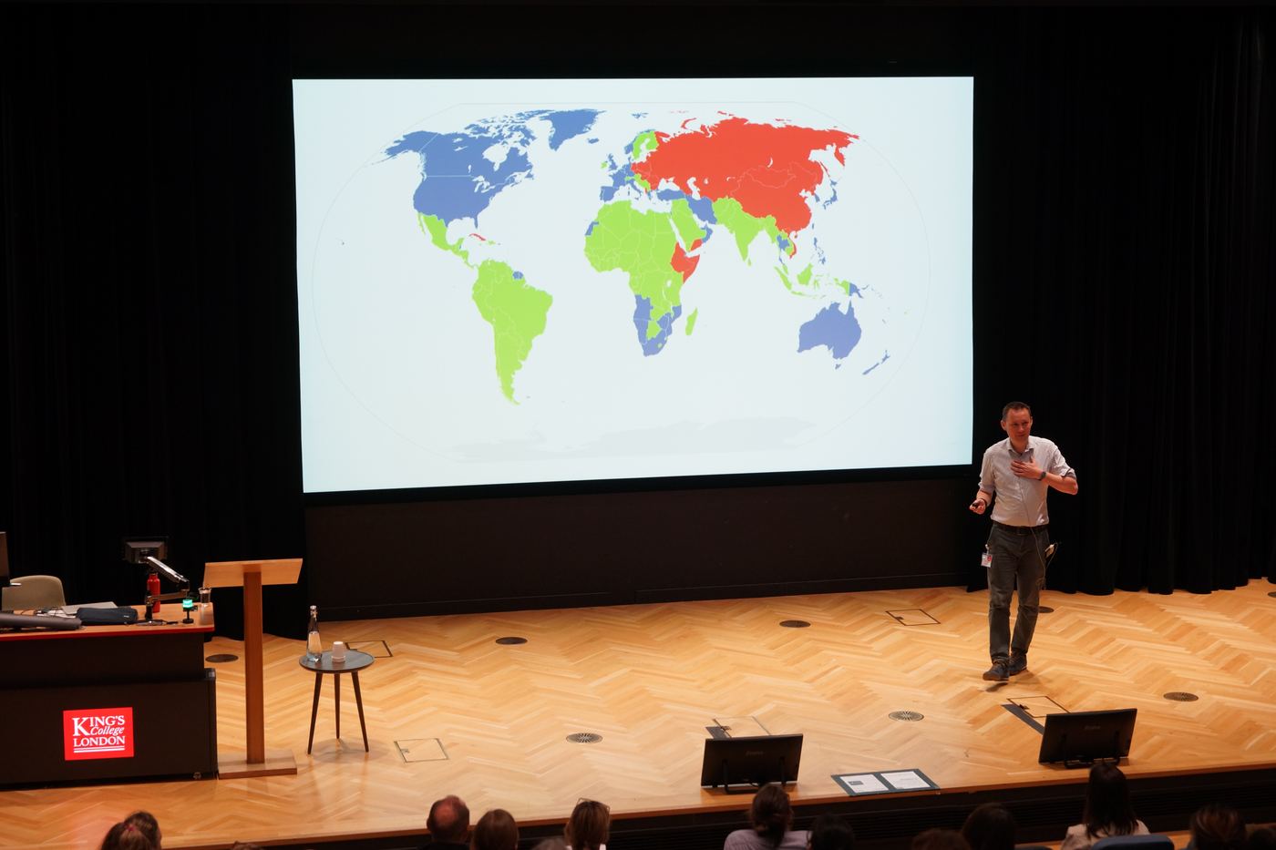 A speaker presenting to the conference